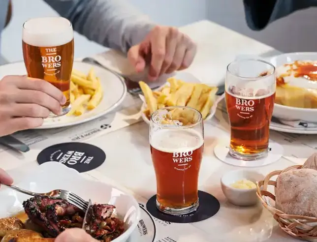 Plates with different foods and glasses of beer